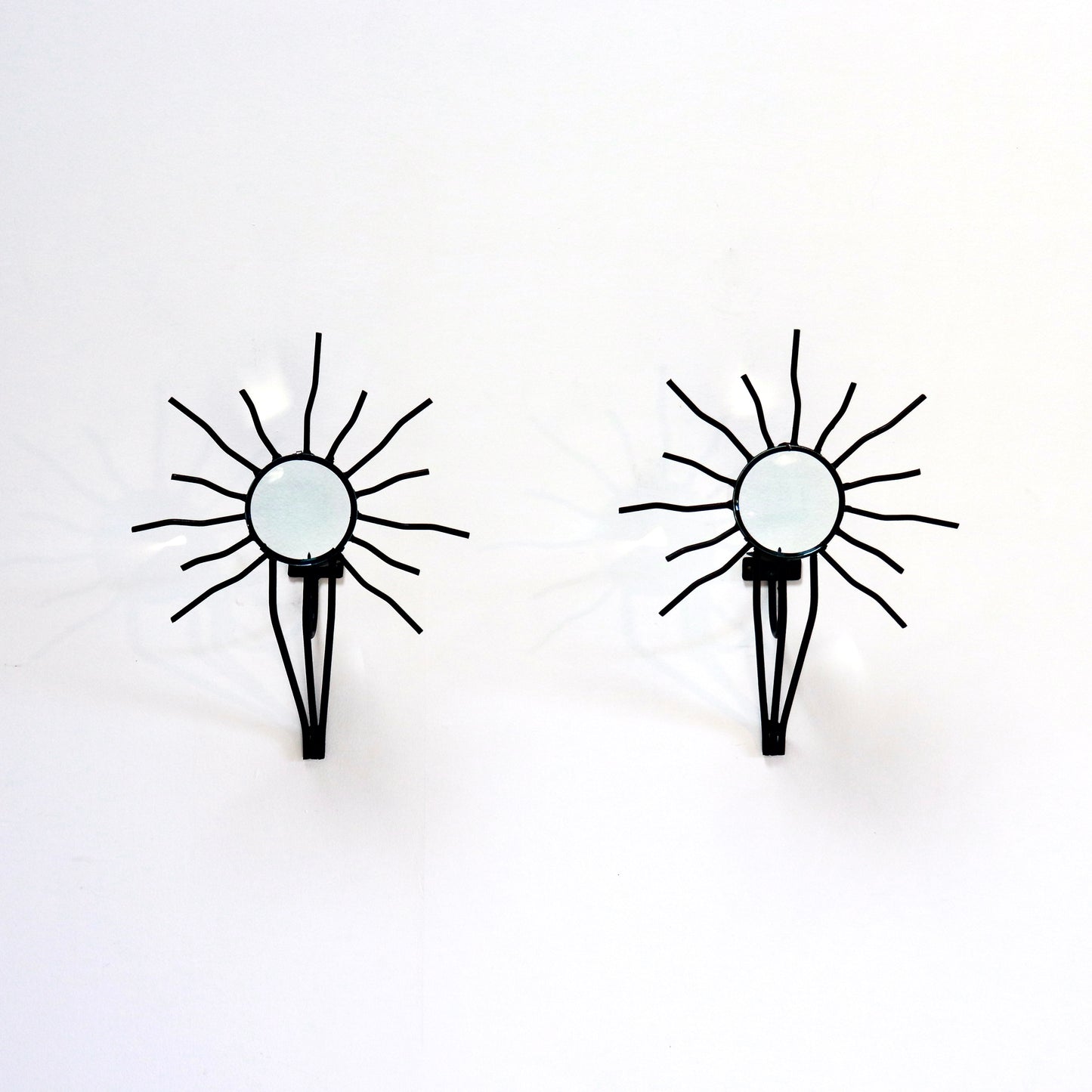 Sunburst wall sconces in the style of Andre Dubreuil