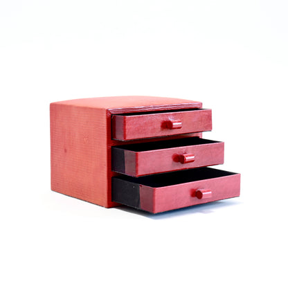 Three open drawers showing the black-lined interiors