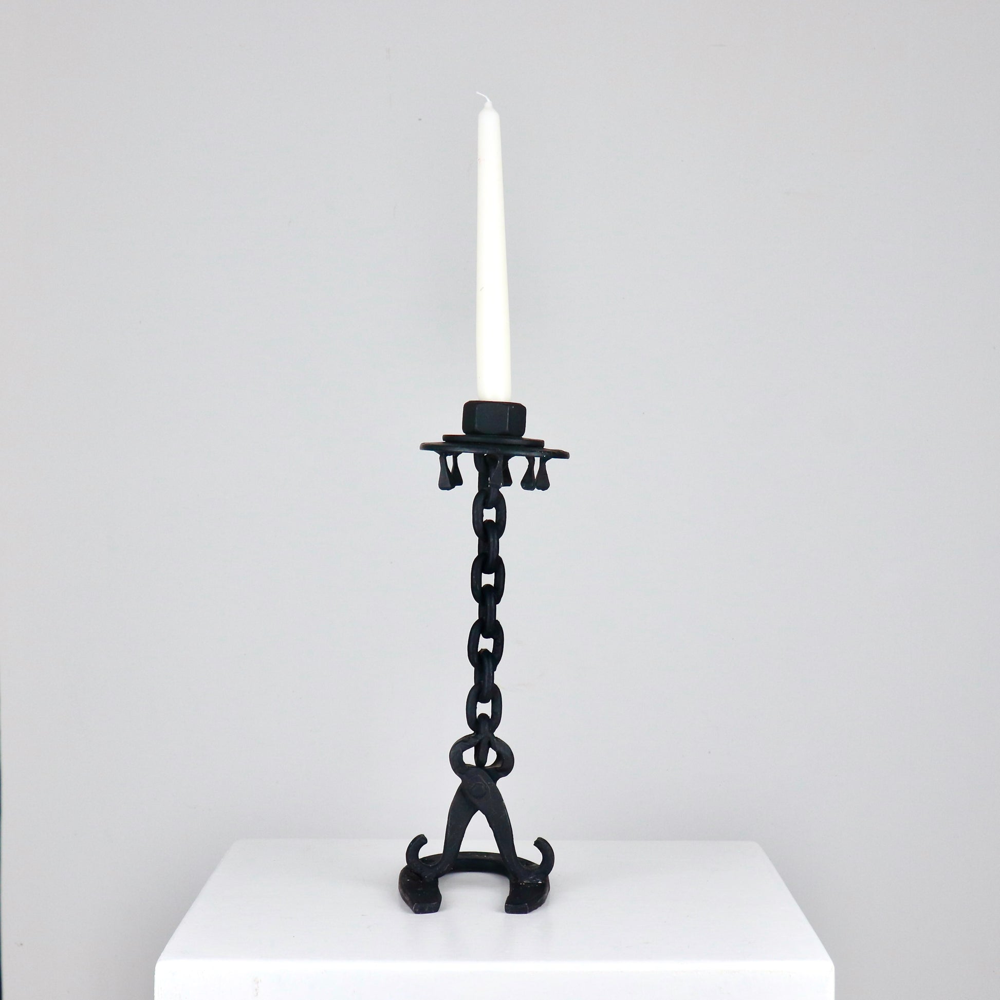 Sculptural workshop-made candlestick in patinated forged metal, H 31 cm