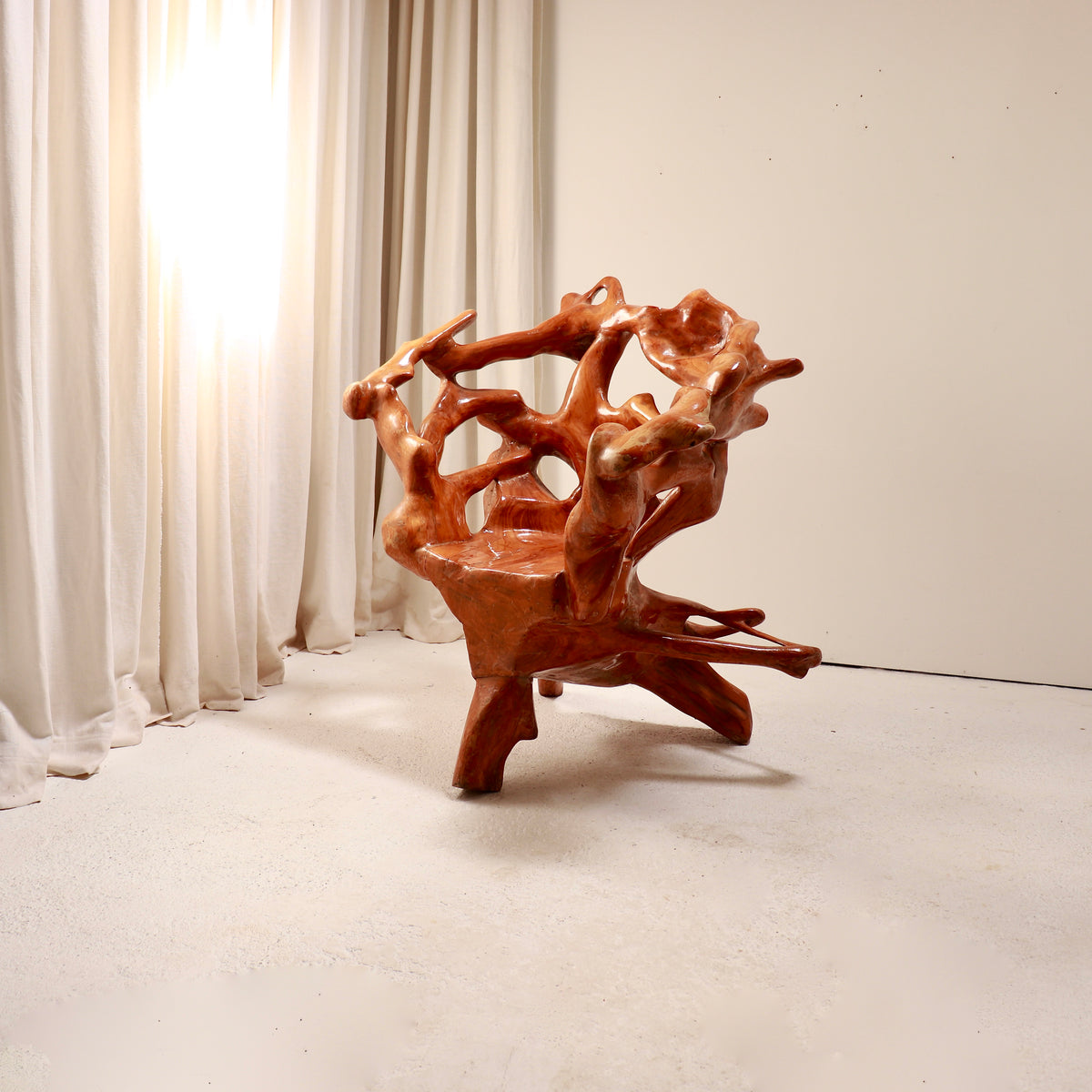 Monumental root wood armchair showing sculptural branching form
