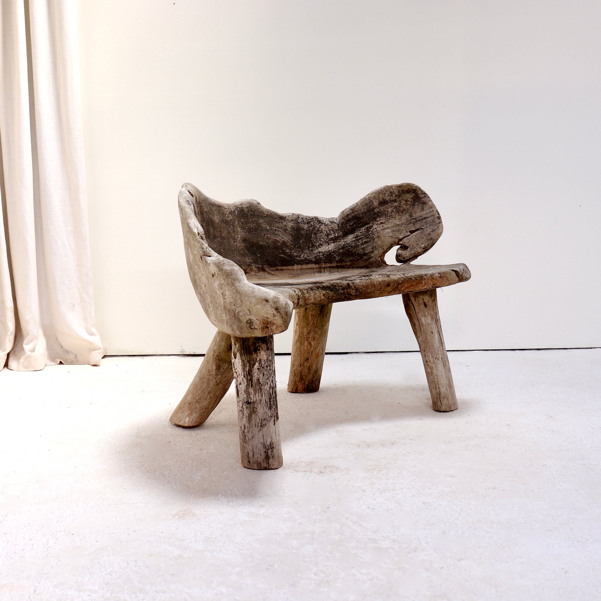 Alternative angle of the hand-carved primitive hardwood garden bench.
