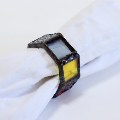 1. Stained glass napkin ring holding a white linen napkin