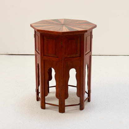 Angled view of the folding wooden side table showing its hinged panels and shaped arches.