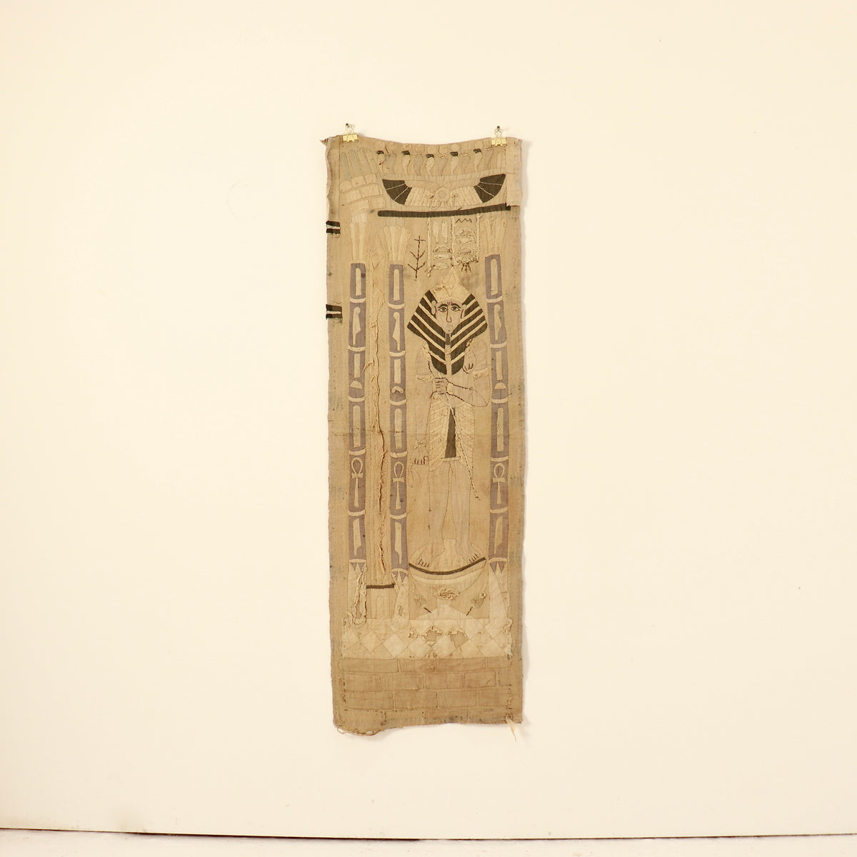 Full view of the narrow textile panel with pharaonic imagery