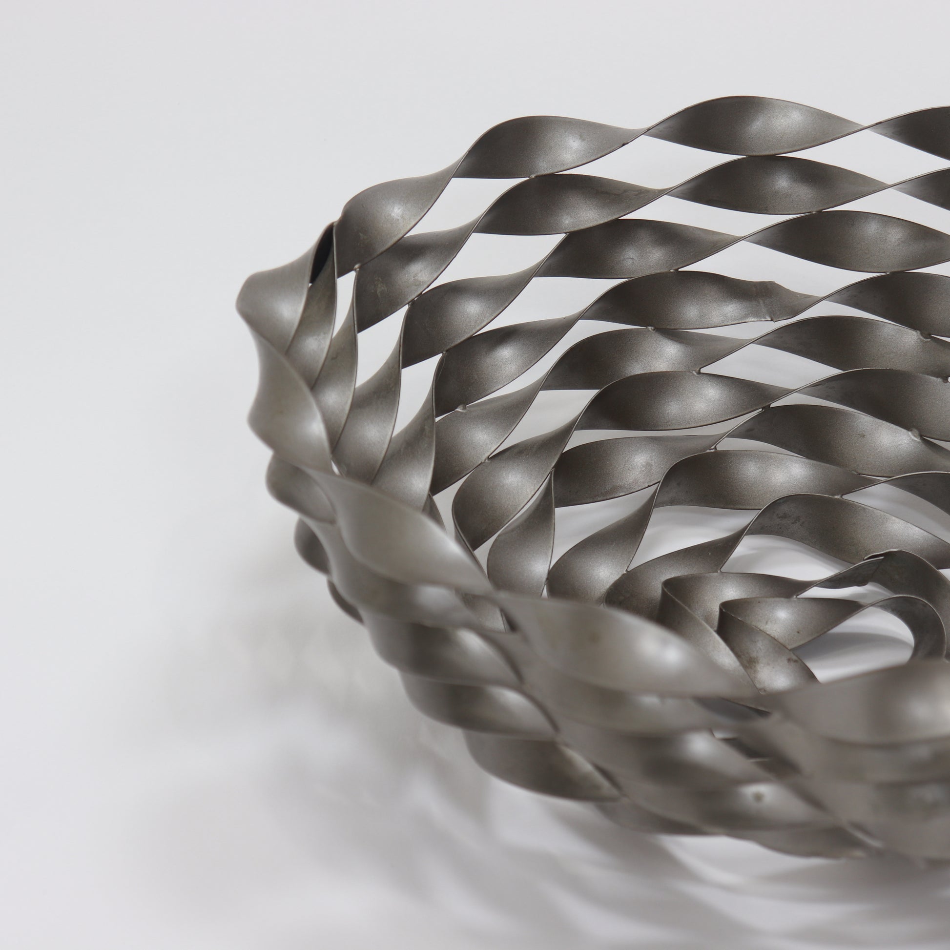 Detail of twisted metal lattice construction with satin linished finish