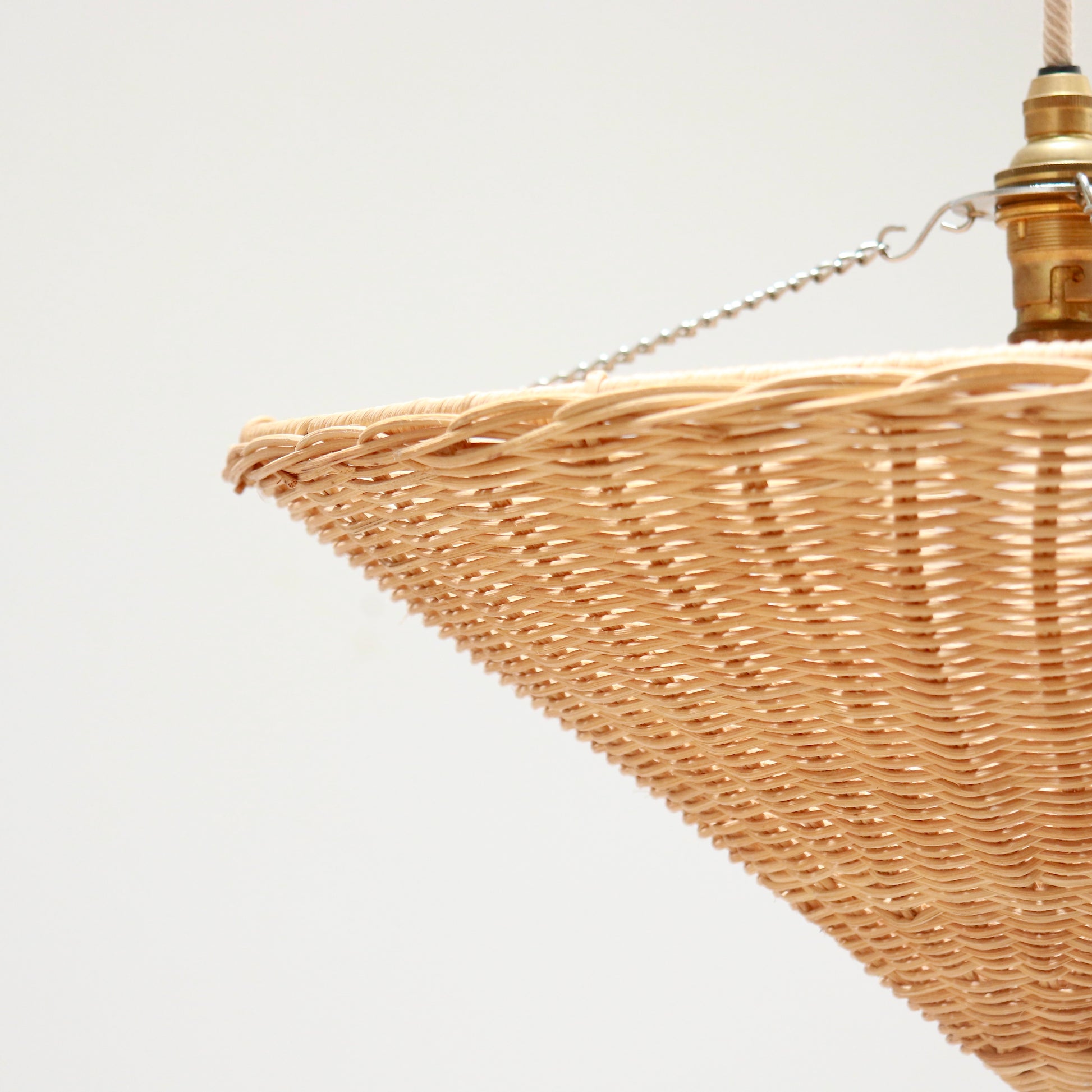 Close-up of rattan weave and rim detail on vintage cone pendant