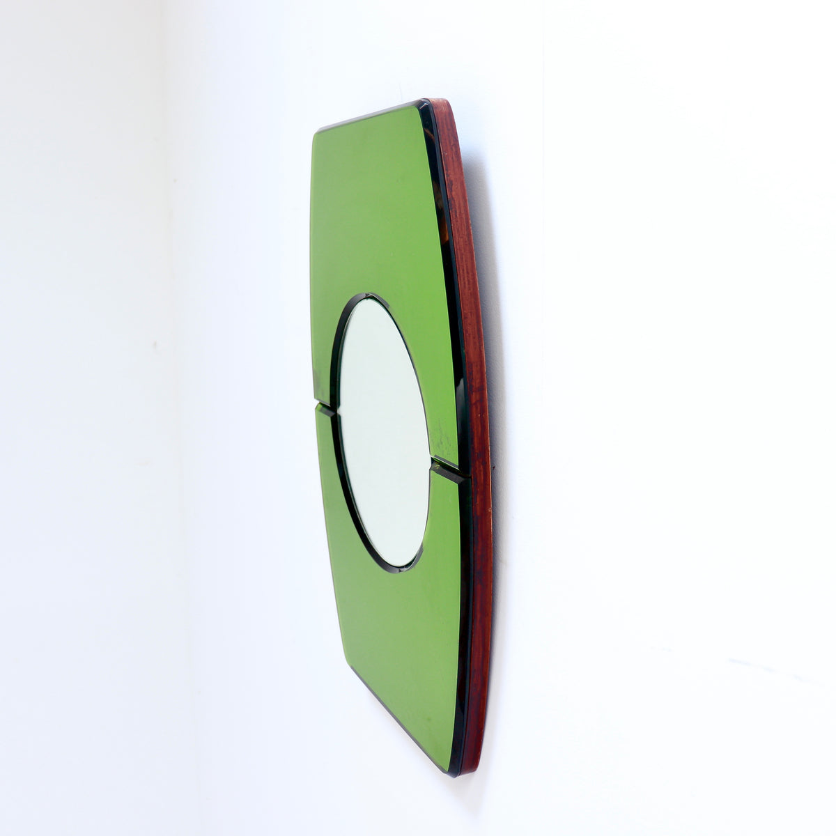 Angled view showing the depth of the convex plate and wooden backing