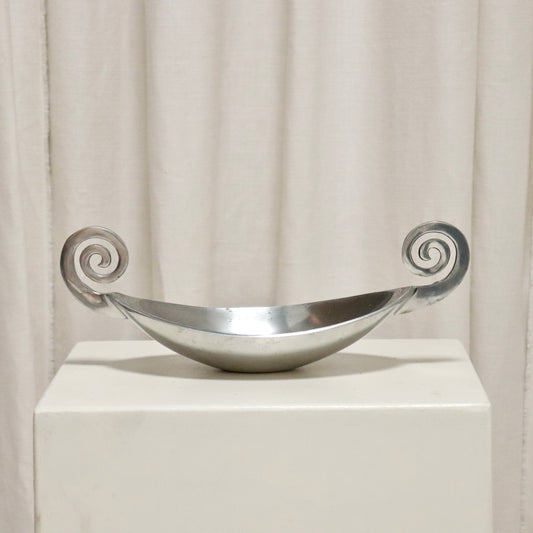 Vintage cast aluminium dish with scroll handles on a plinth.