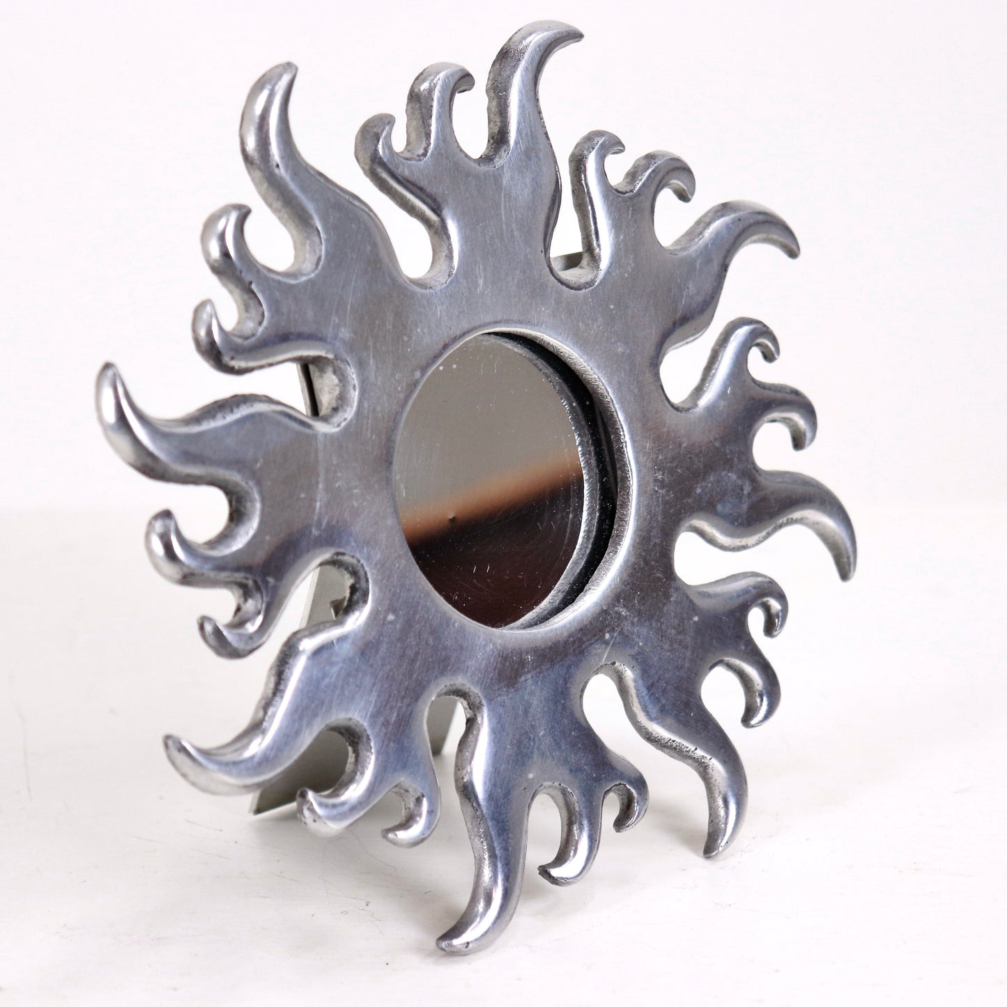 Small aluminium flame mirror freestanding on tabletop