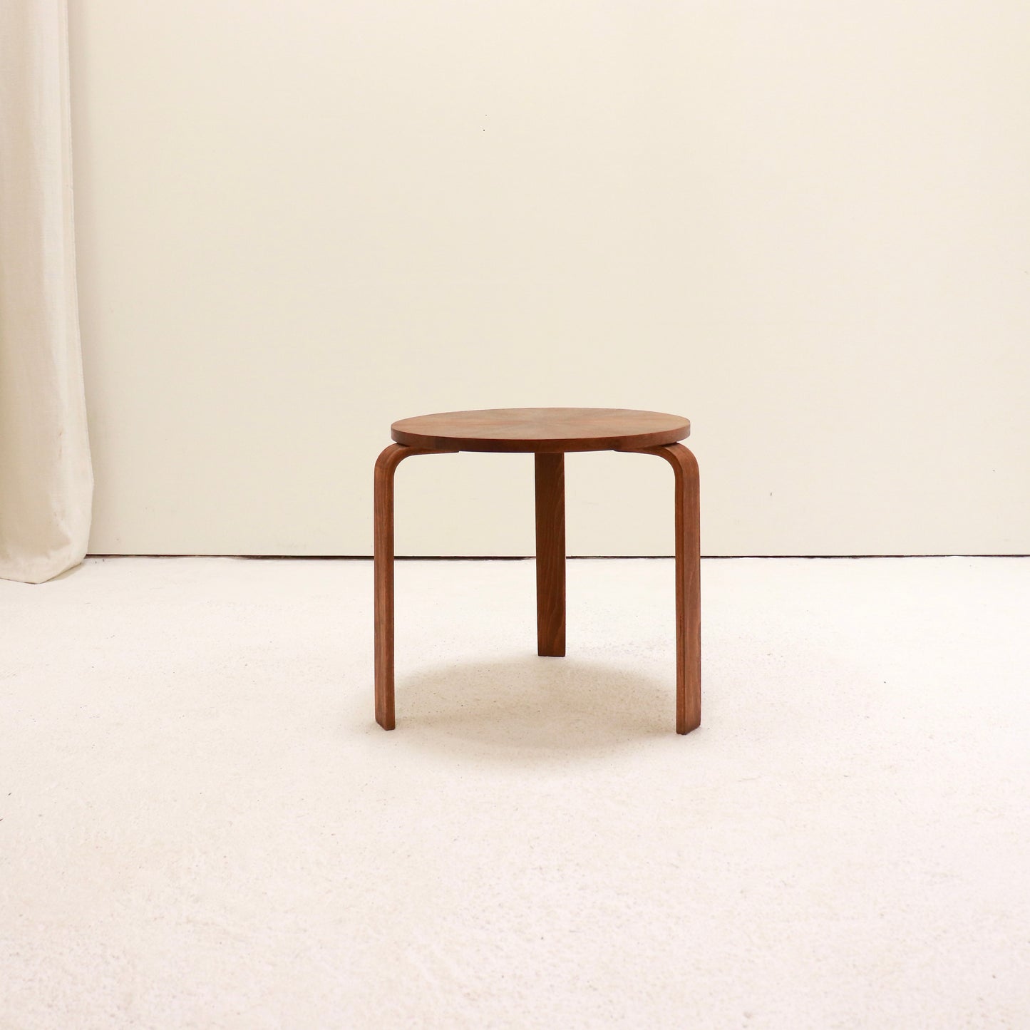 Small Scandinavian style round side table in warm wood