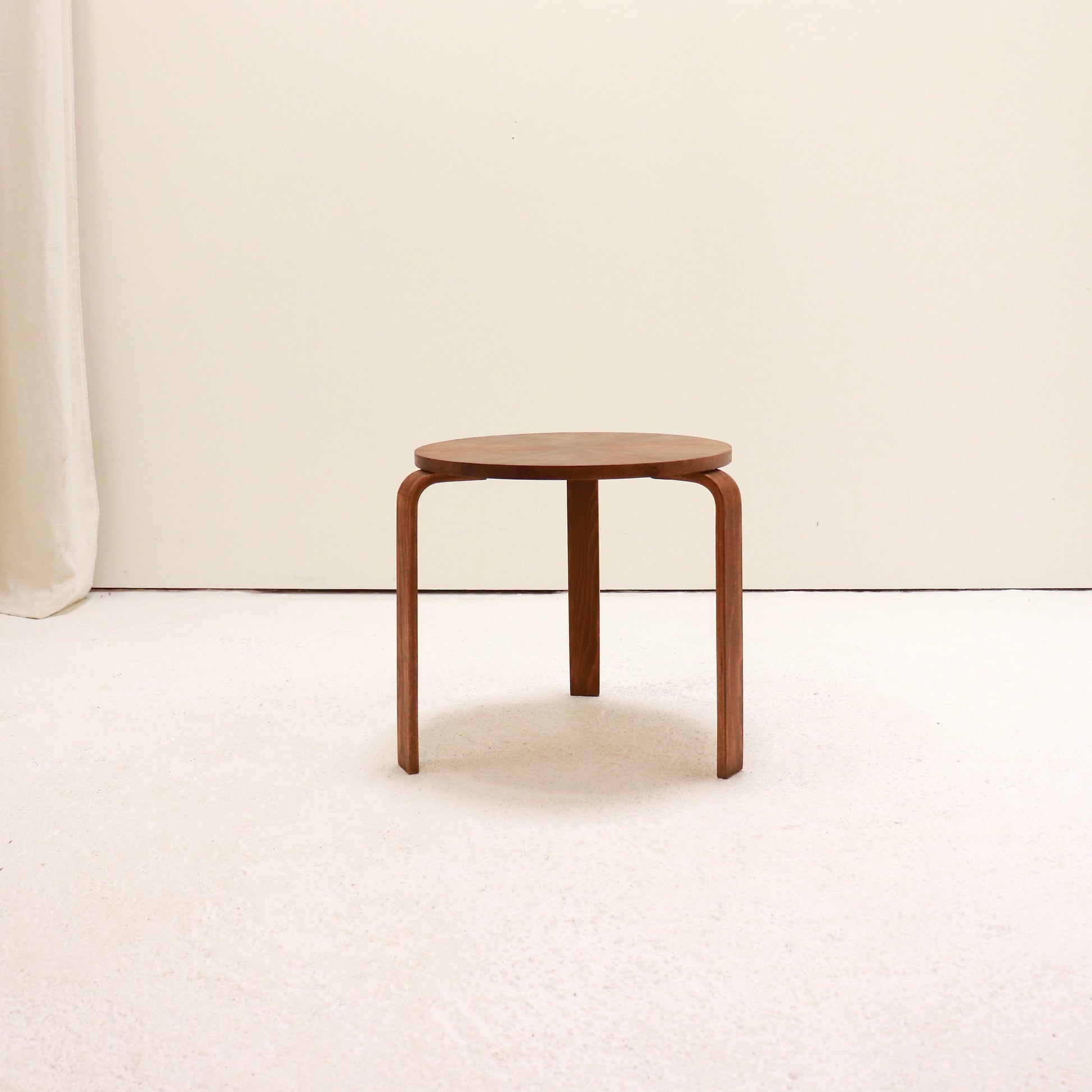 Small Scandinavian style round side table in warm wood