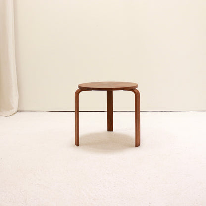 Small Scandinavian style round side table in warm wood