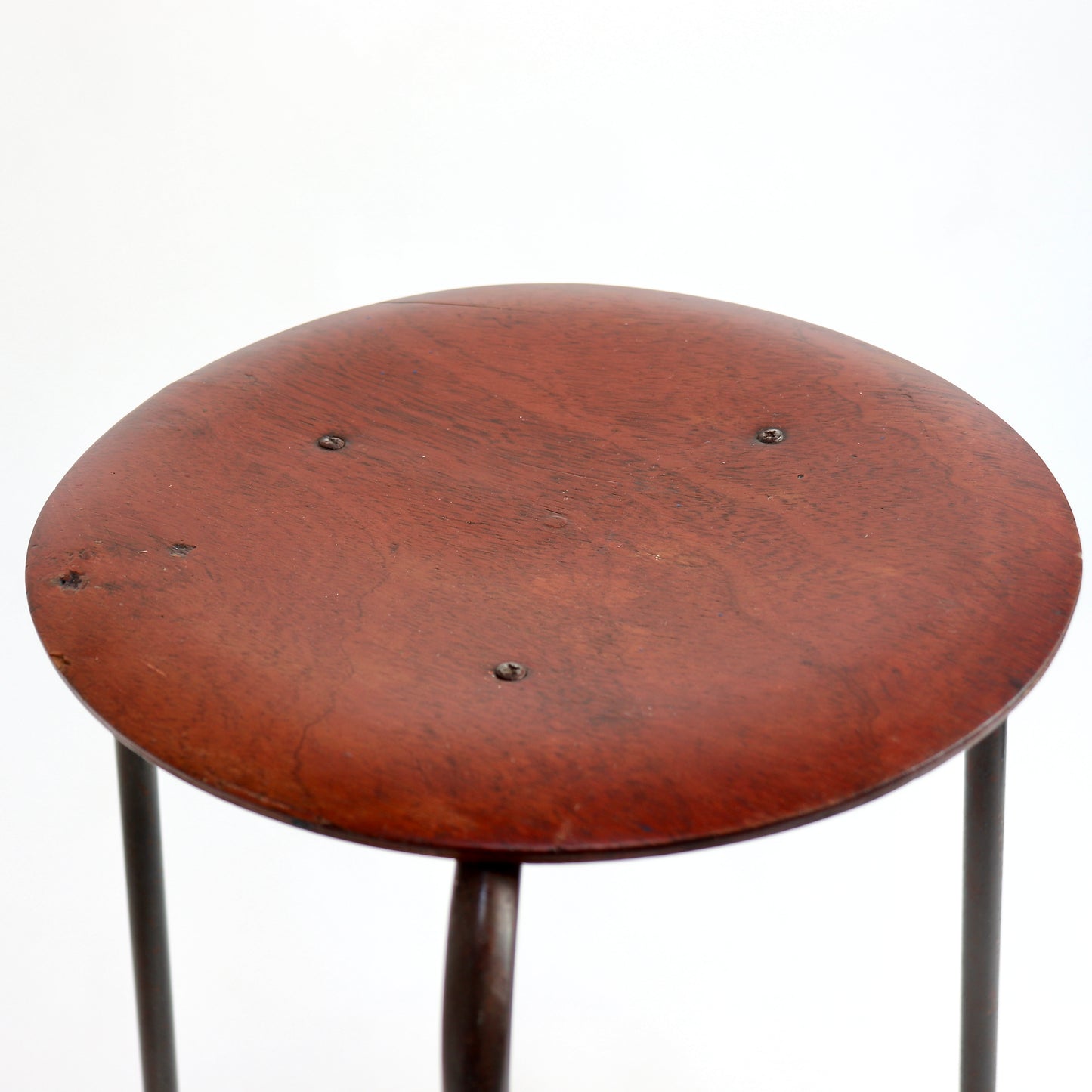 Circular timber seat with warm reddish-brown finish