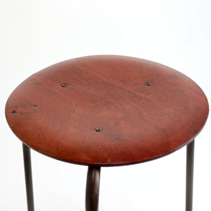 Circular timber seat with warm reddish-brown finish