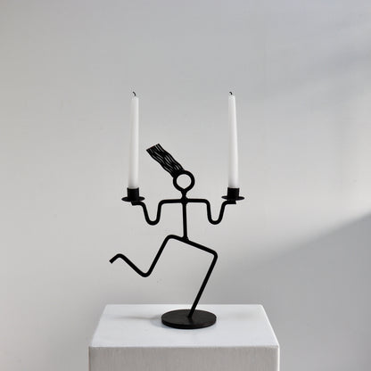 Figural iron candle holder with running figure form