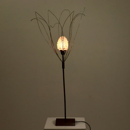 Full height view of copper and wirework sculptural lamp