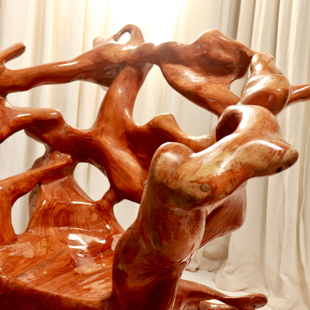 Sculptural root wood chair showing natural fissures and grain
