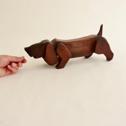 Carved wooden dachshund sculpture side view

