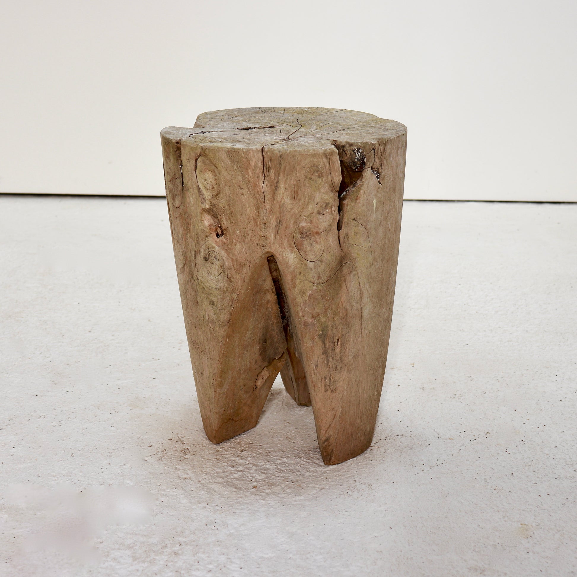 Primitive hardwood stump stool carved from a solid tree section.