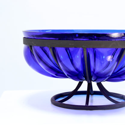 Sculptural blue glass bowl on metal base