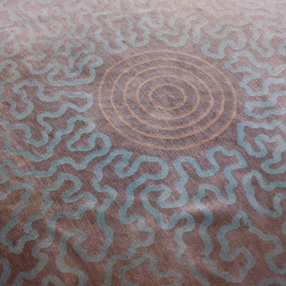Close view of the concentric peach rings surrounded by pale aqua abstract lines.