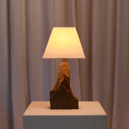 Mid-century slate lamp lit with warm ambient glow
