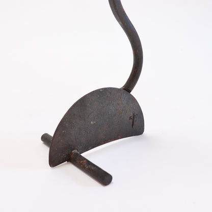Reverse detail of the candlestick base showing the flattened stem attachment and transverse foot.