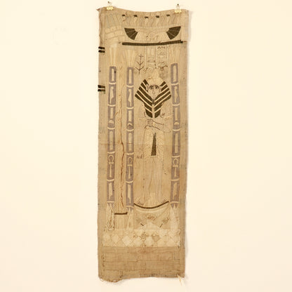 Long Egyptian Revival appliqué wall hanging displayed on a pale wall