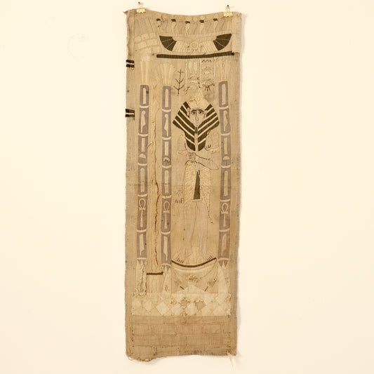 Long Egyptian Revival appliqué wall hanging displayed on a pale wall