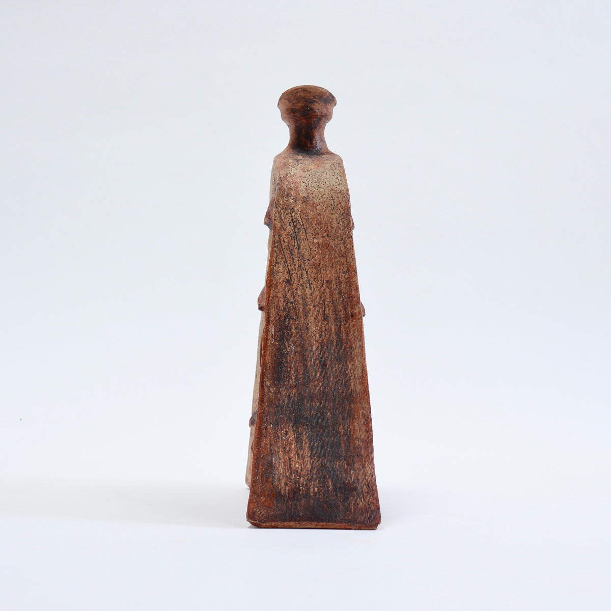 Side profile of a mid-century Cornish pottery vessel showing its shallow depth, tapering body and narrow neck.