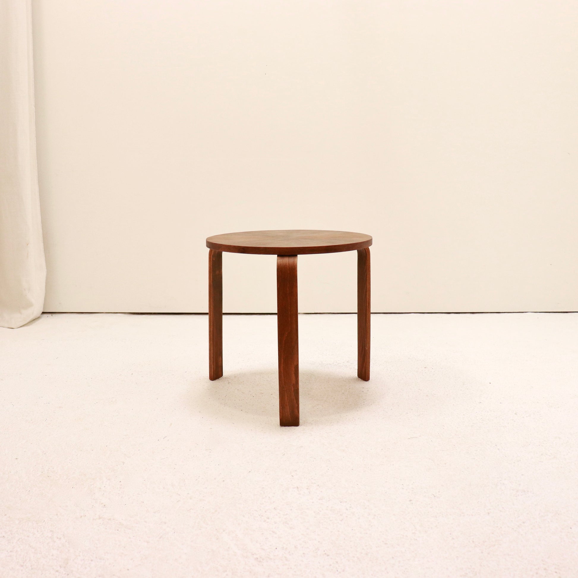 Minimal three-leg wooden table with curved legs