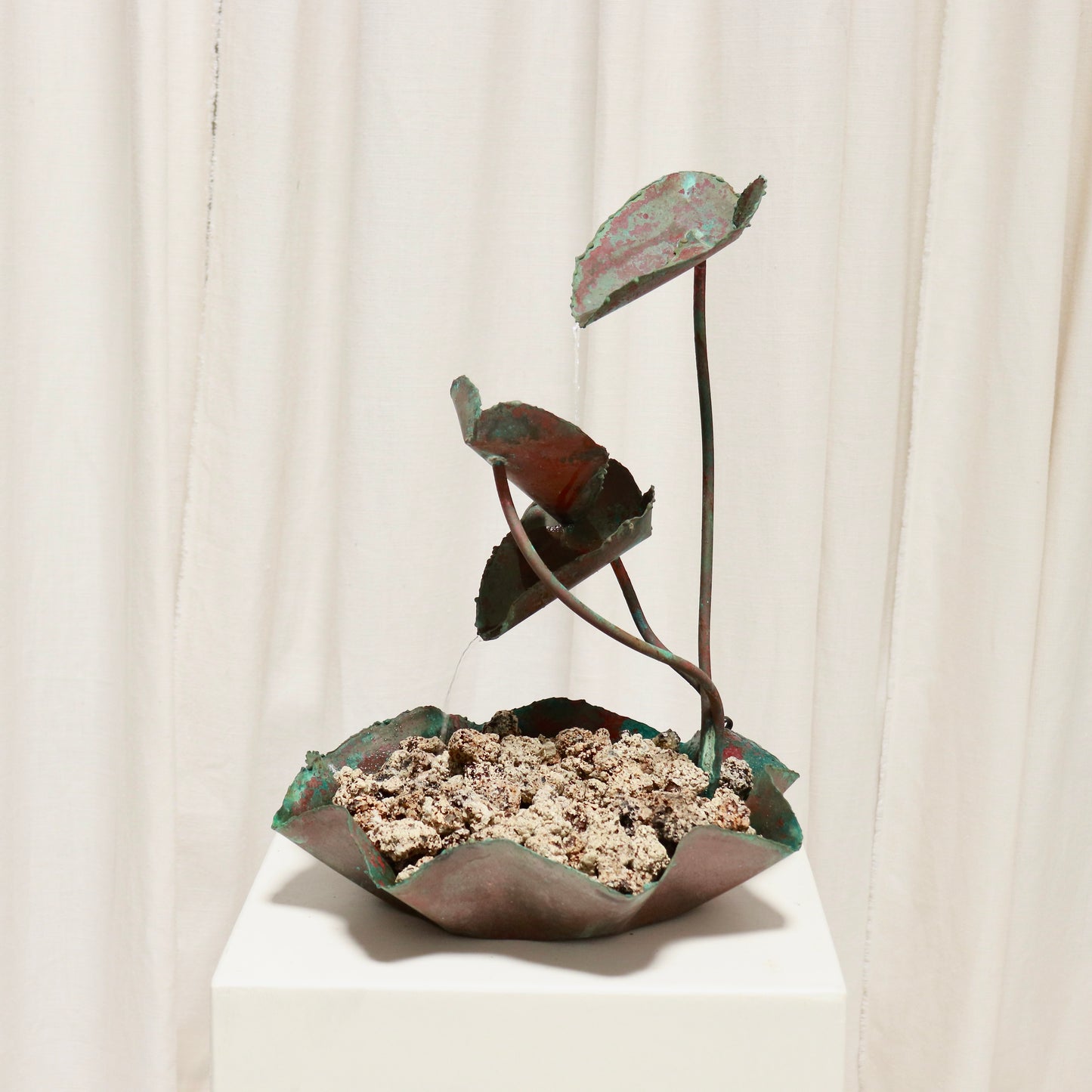 Side view showing three cascading leaf cups and fluted basin.