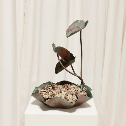 Side view showing three cascading leaf cups and fluted basin.