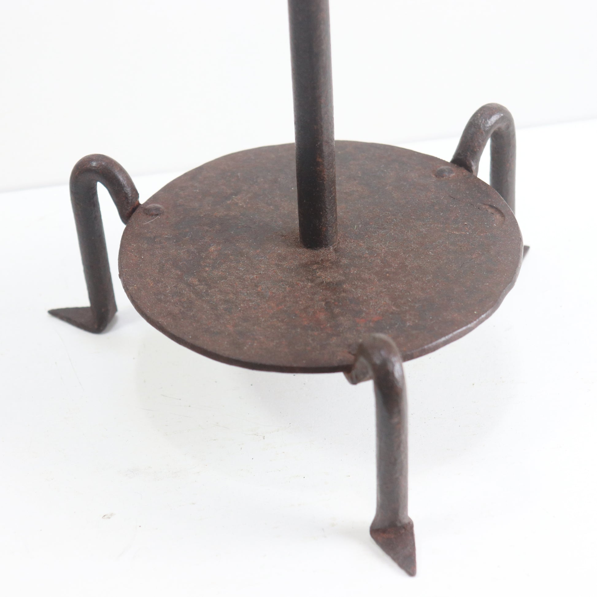 Hand-forged iron legs on candle stand