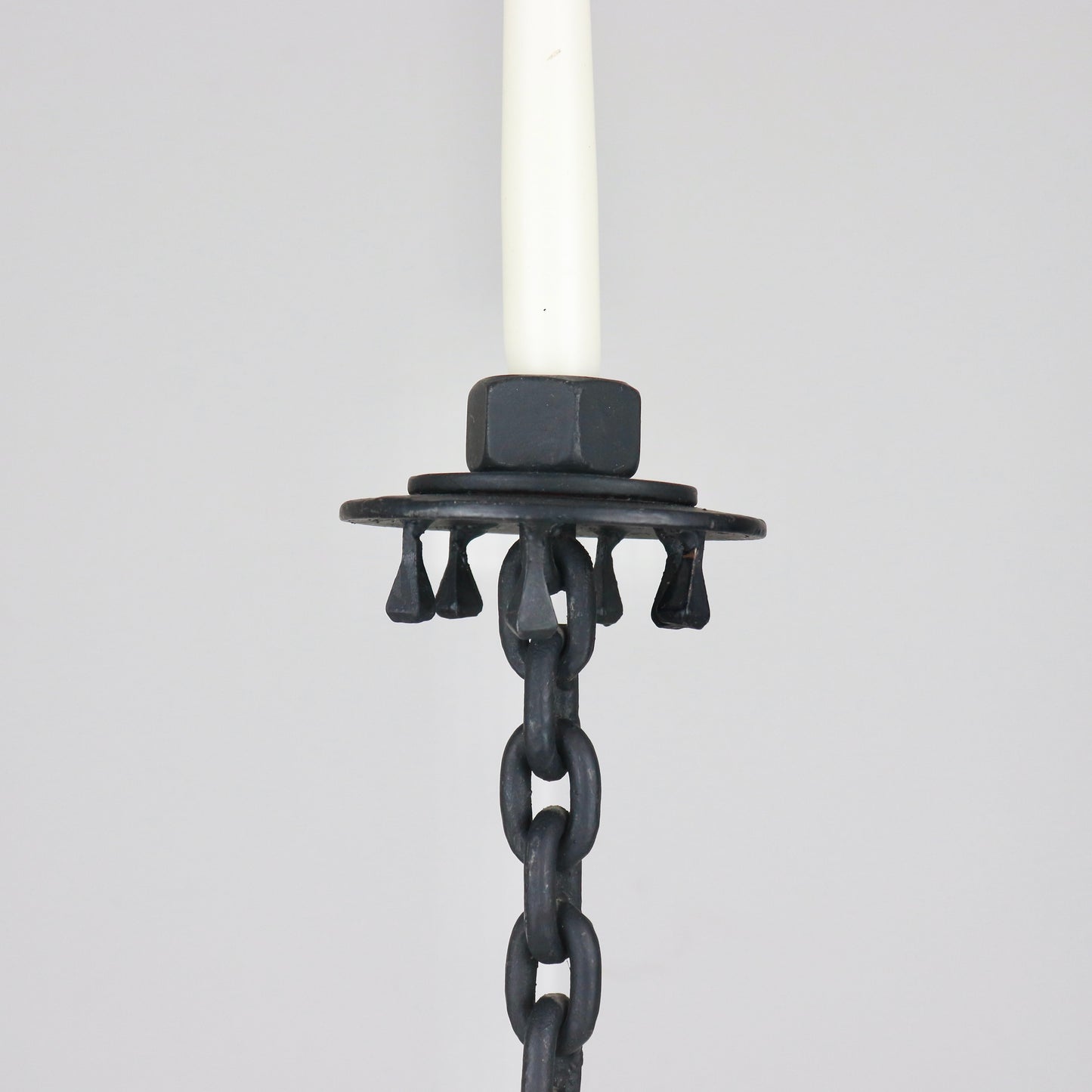 Vintage iron candlestick with horseshoe-style base and dark patina