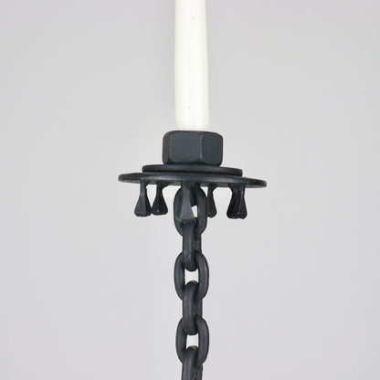 Vintage iron candlestick with horseshoe-style base and dark patina