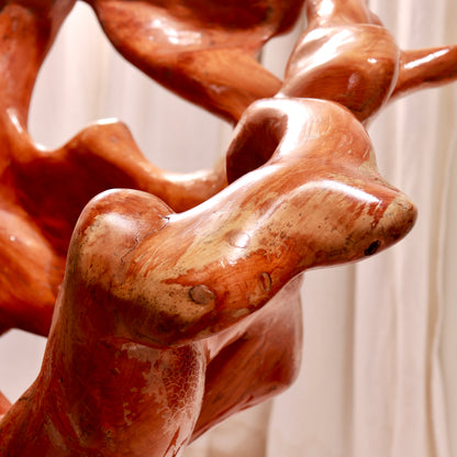 Close-up of biomorphic carved root wood arm
