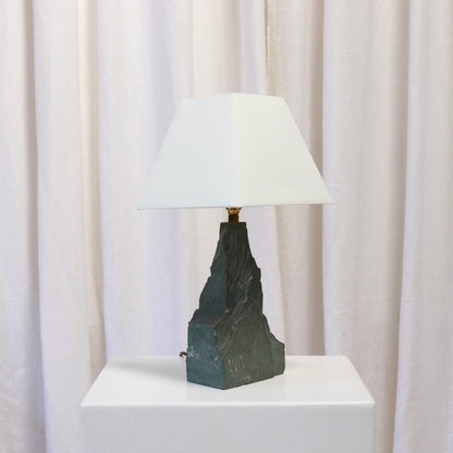 Side view of brutalist stone lamp base