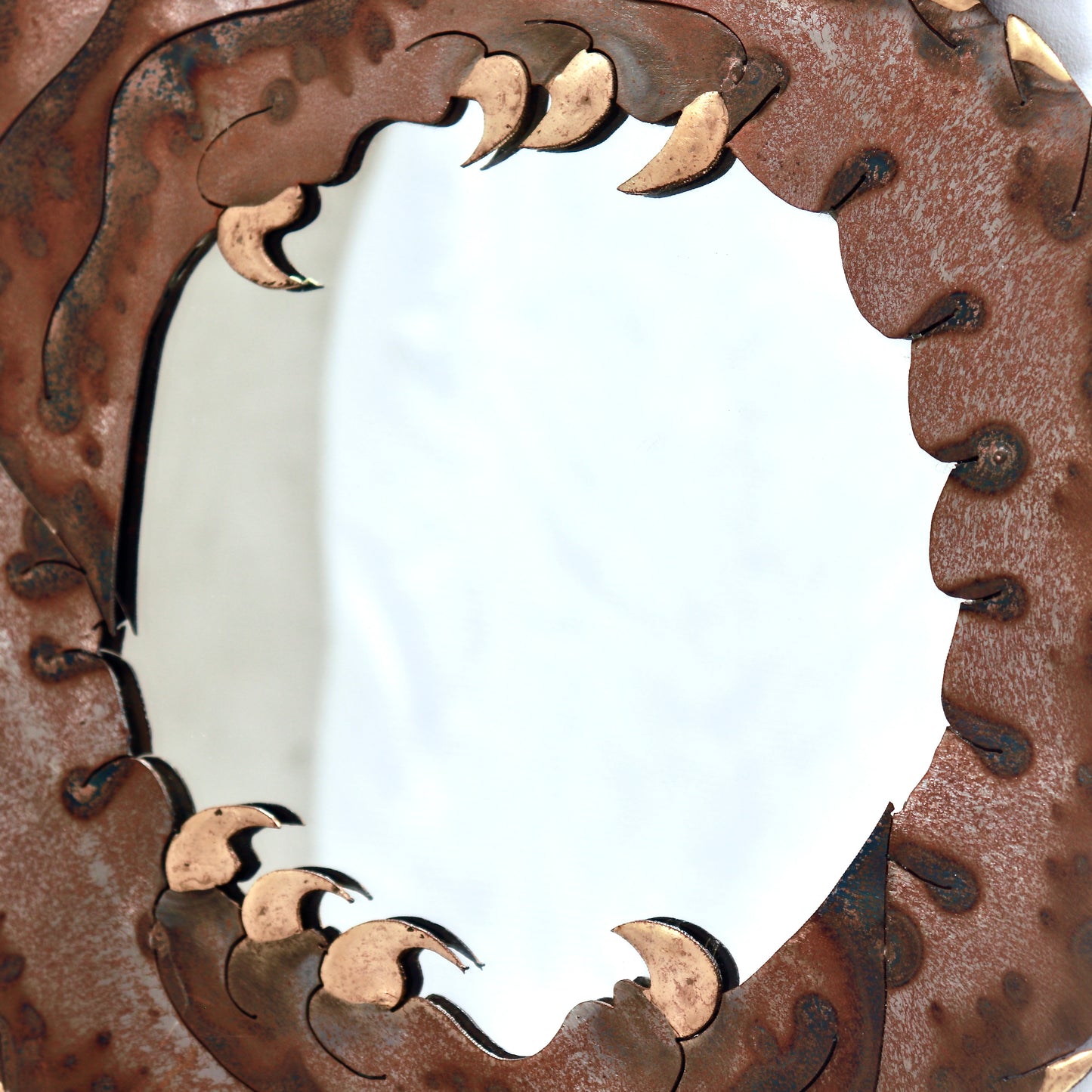 Close-up of brass detailing on vintage dragon mirror
