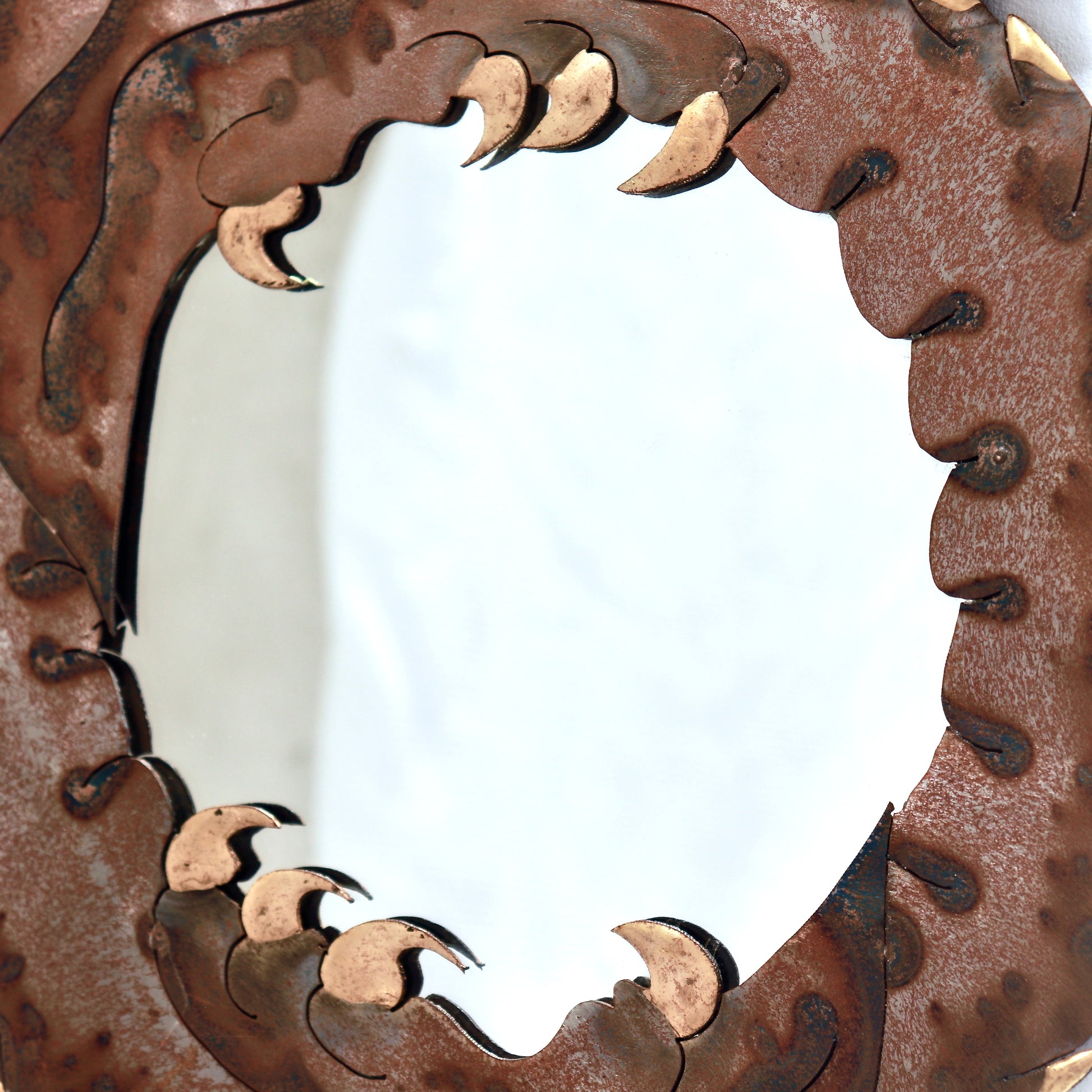 Close-up of brass detailing on vintage dragon mirror