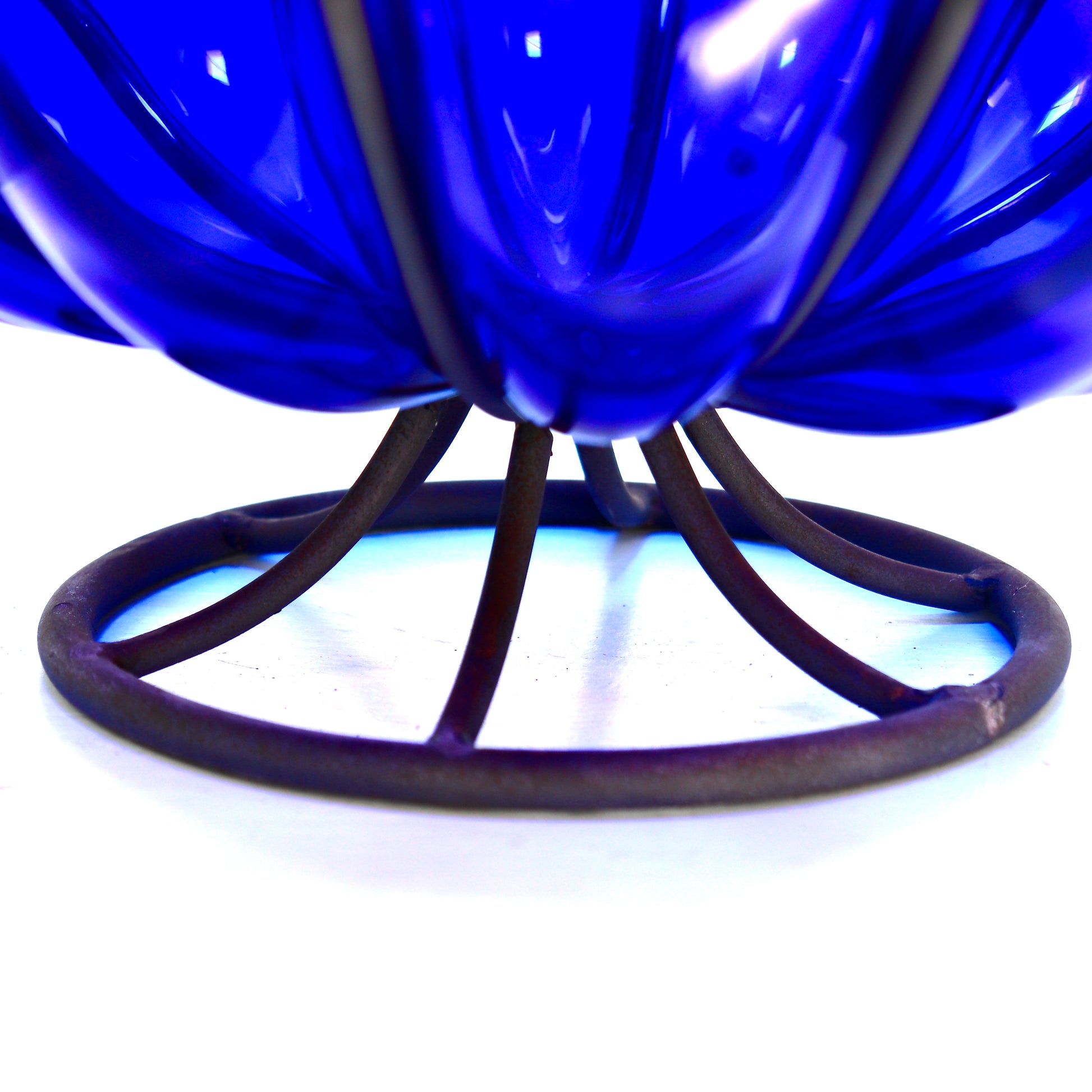 Deep blue glass decorative bowl in metal structure