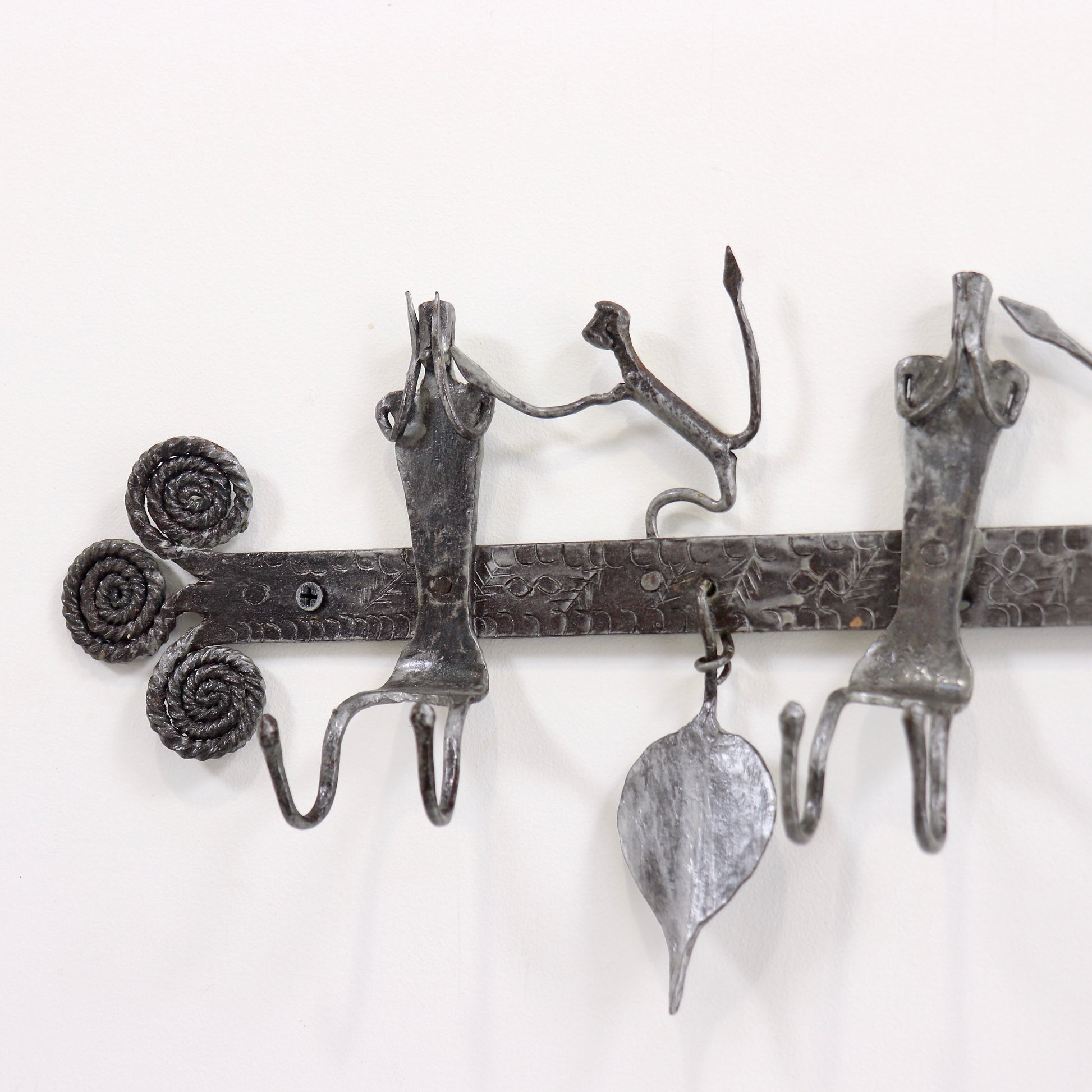 Wrought iron coat rack with hanging details