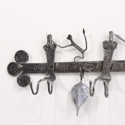 Wrought iron coat rack with hanging details