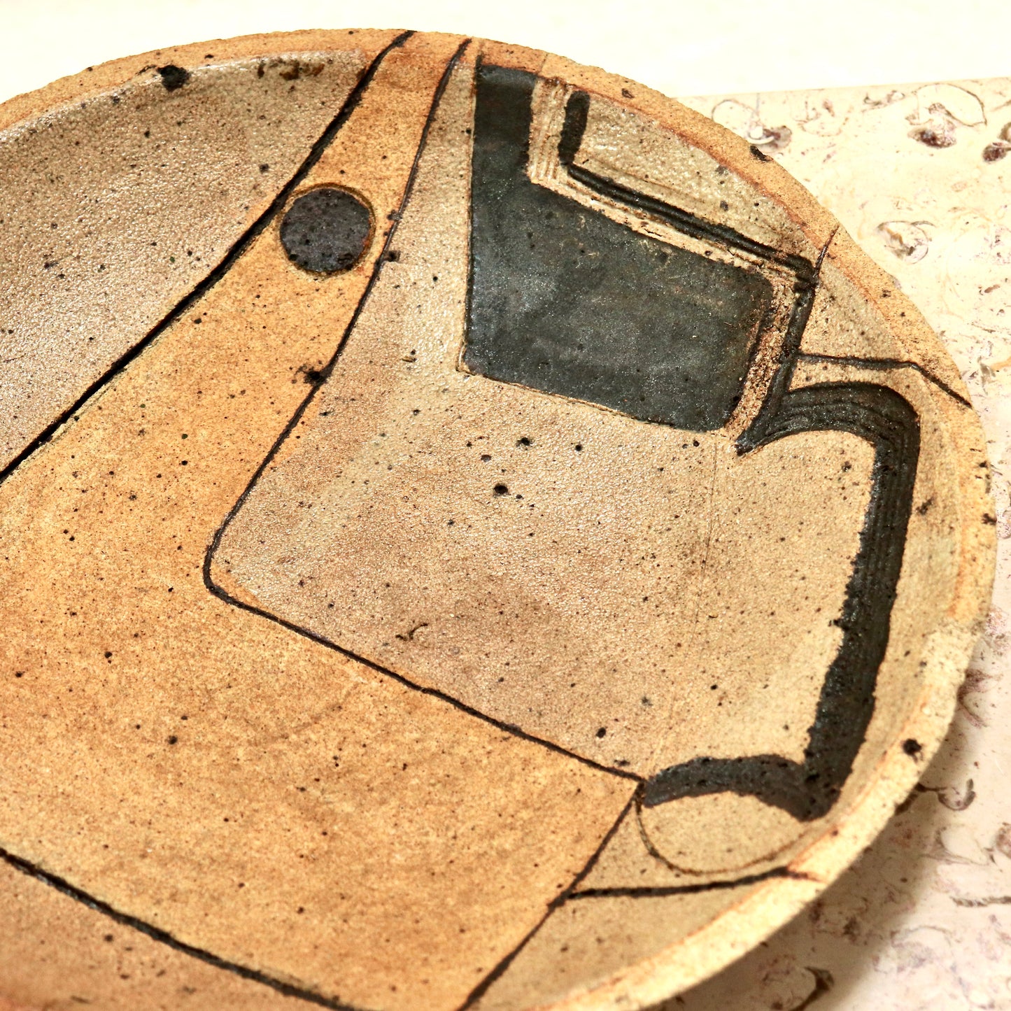 Textured pottery platter with geometric brushwork