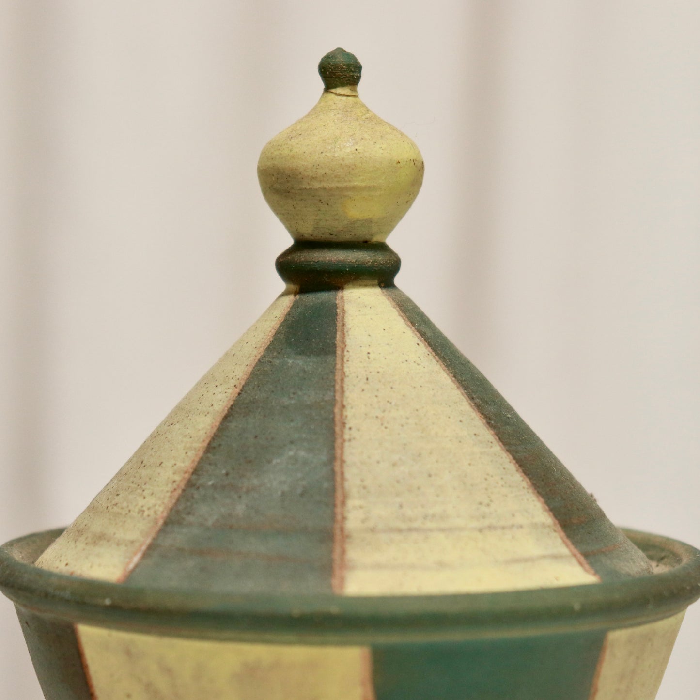 Close-up of cone lid showing alternating green and buttermilk stripes.