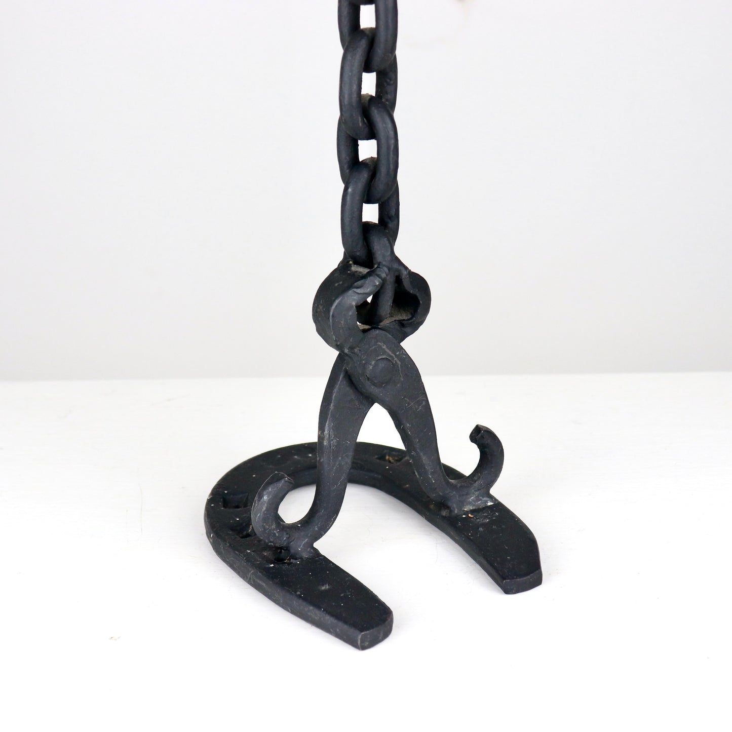 Detail of chain link construction on handmade iron candlestick