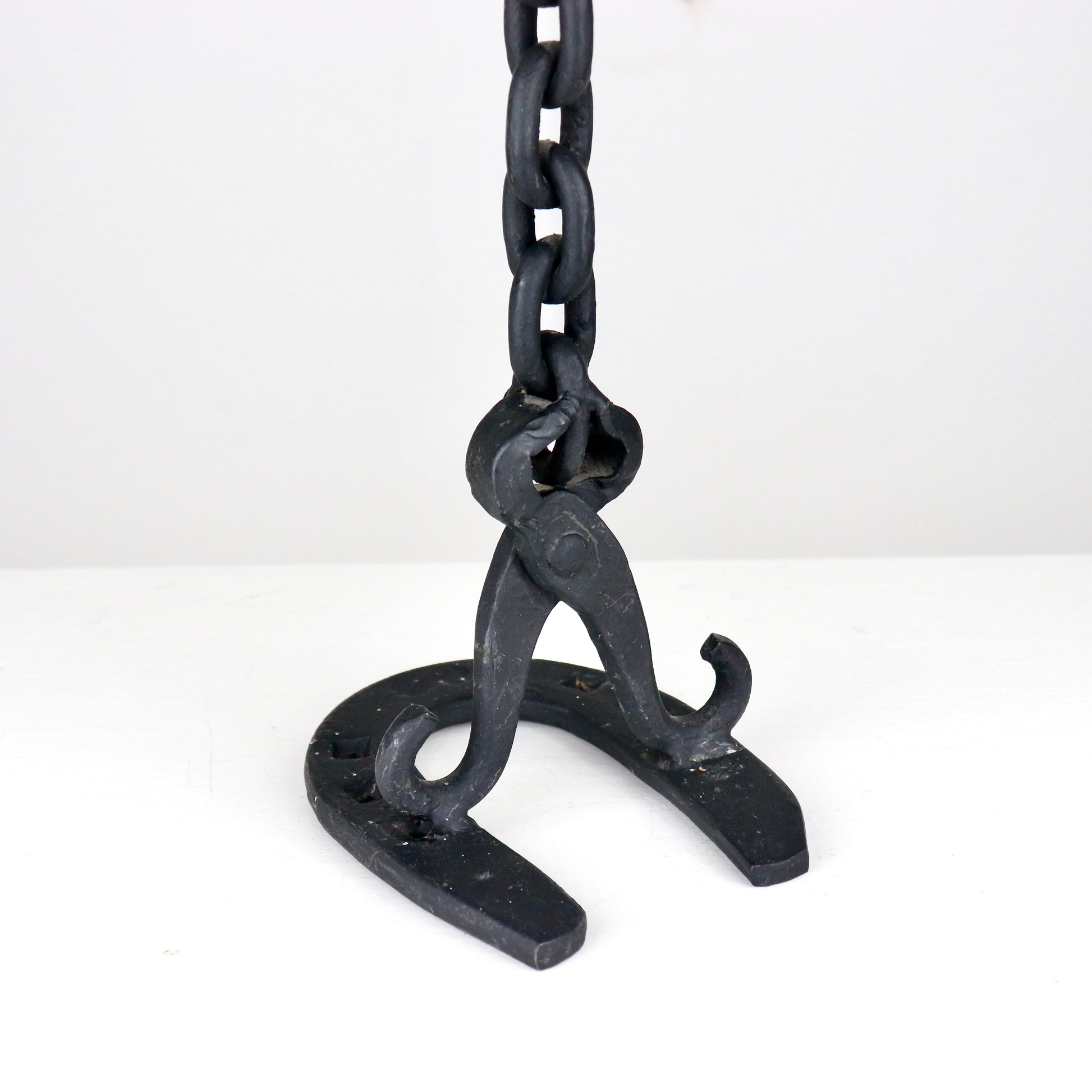 Detail of chain link construction on handmade iron candlestick