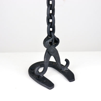 Detail of chain link construction on handmade iron candlestick