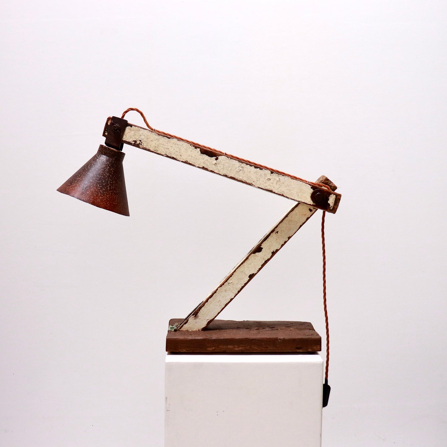 Rustic articulated lamp with salvaged wooden arms