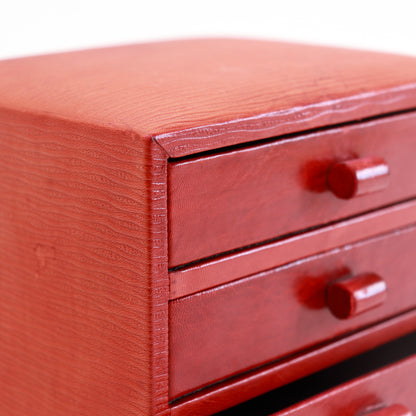 Close-up of the textured red leather covering and drawer fronts